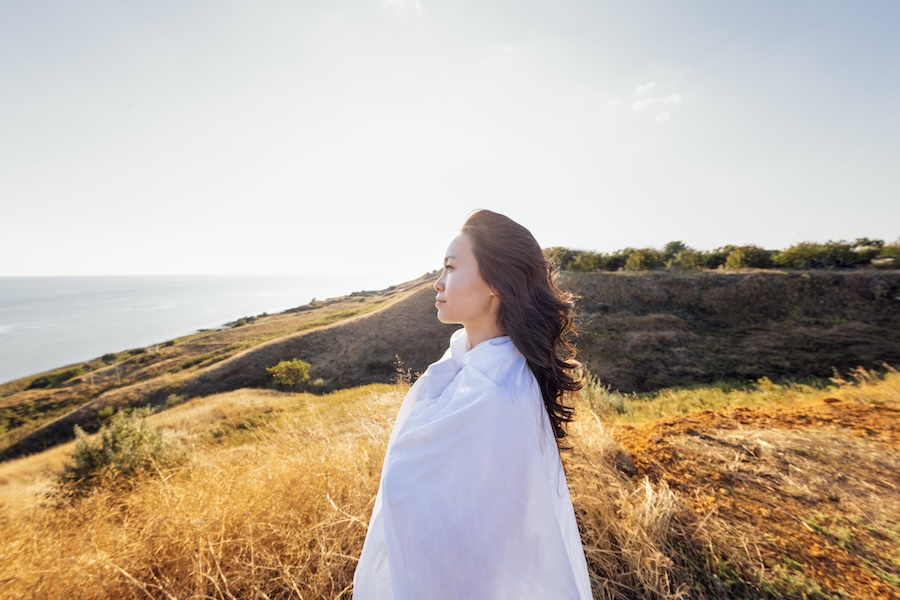 a woman looking out to the sea searching for answers